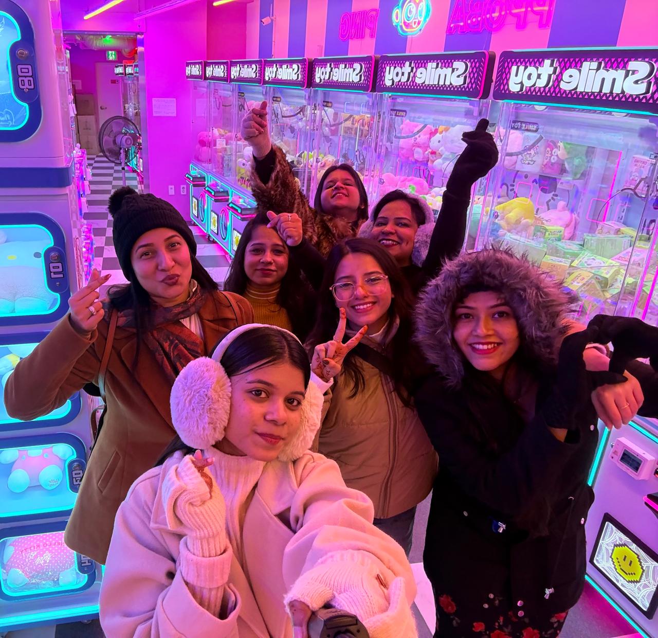 Travelers enjoying an arcade together